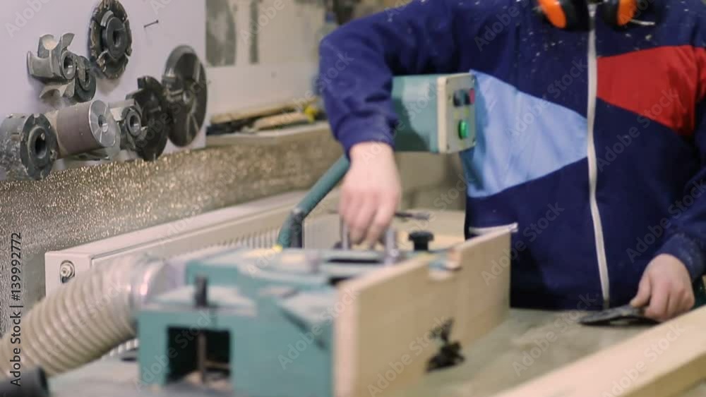 Carpenter installing circular saw blade on machine Carpenter installing circular saw blade on machine