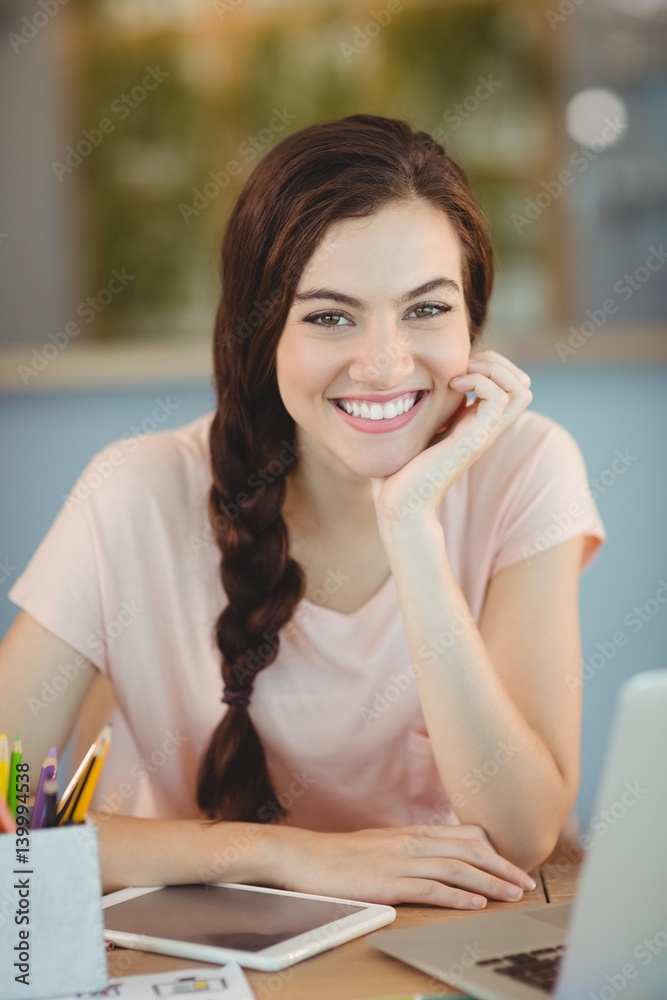 Portrait of beautiful executive sitting at desk Portrait of beautiful executive sitting at desk