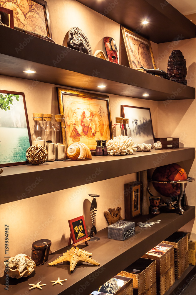 Interior design shelves with travel souvenirs and accessories in