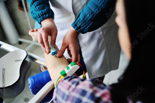 Doctor making blood analysis young girl patient. Blood sampling from a vein on the background of the clinic © Evgeniy Kalinovskiy