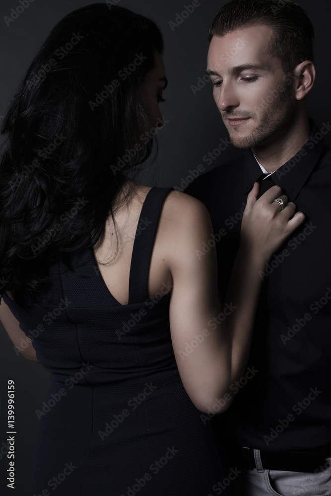 Beautiful woman touching an handsome man . Attractive couple Beautiful woman touching an handsome man . Attractive couple