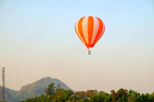 Hot air balloon flying on sky and landscape background