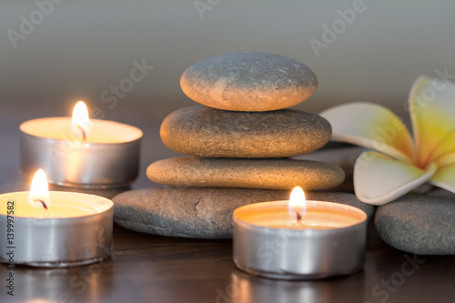 stack of pebble stones and burning candles