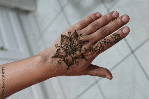 henna, tatoo on a senior woman hand