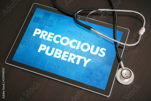 Precocious puberty (endocrine disease related) diagnosis medical concept on tablet screen with stethoscope photo