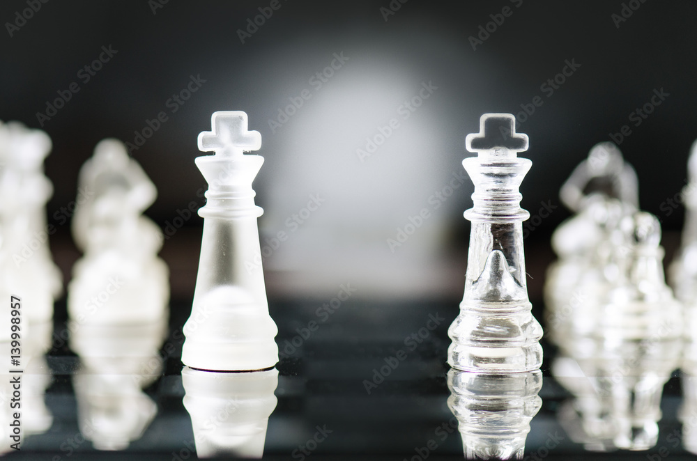 Chess business concept of victory. Chess figures in a reflection of chessboard. Game. Competition and intelligence concept. Chess business concept of victory. Chess figures in a reflection of chessboard. Game. Competition and intelligence concept.