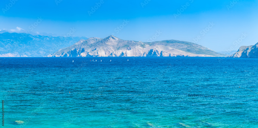 Wonderful romantic summer afternoon seascape Adriatic island. Yachts in harbor at cristal clear turquoise water. Baska on the island of Krk. Croatia. Europe.