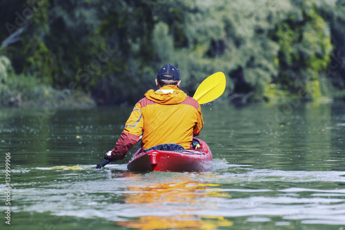 Fototapeta Naklejka Na Ścianę i Meble -  A trip by the river on a kayak.
