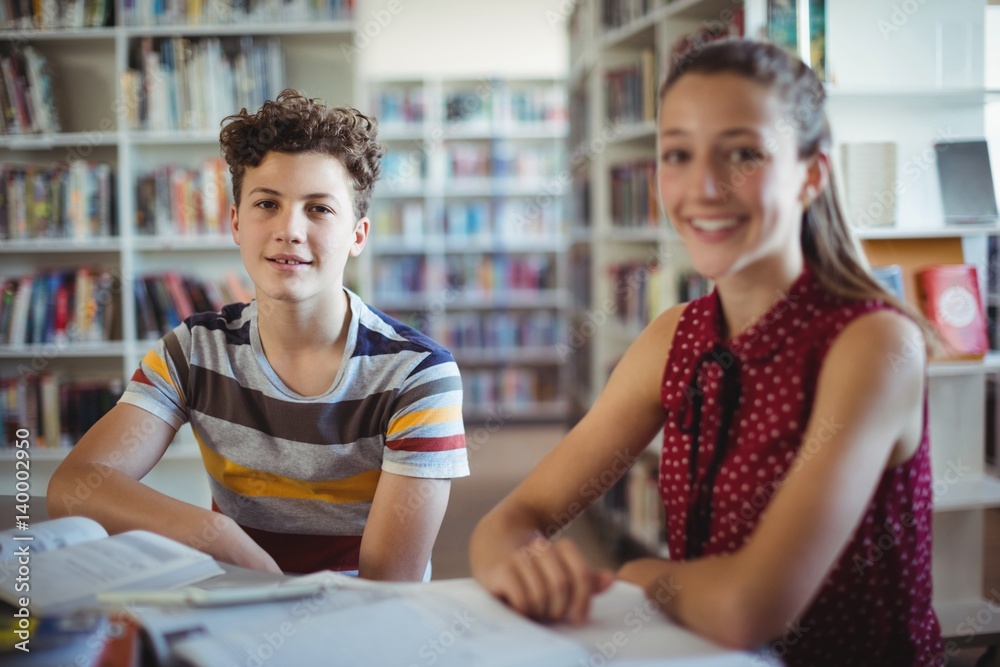 happy schoolboy sitting with his classmate happy schoolboy sitting with his classmate