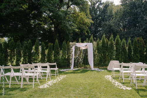 Beautiful wedding archway. Arch decorated with biege cloth and flowers