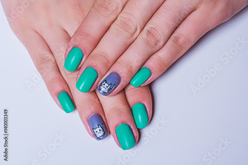 Nail art in turquoise with white cat on grey