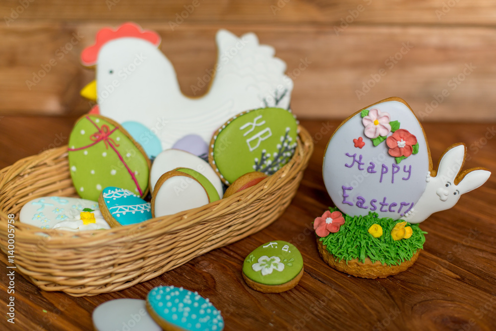 Colorful easter cookies in basket on wooden background. Happy Easter.