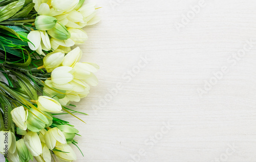 Spring tulips lying on white wooden table background