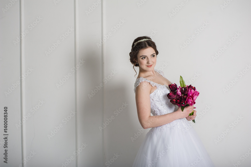 Smiling bride holding big wedding bouquet