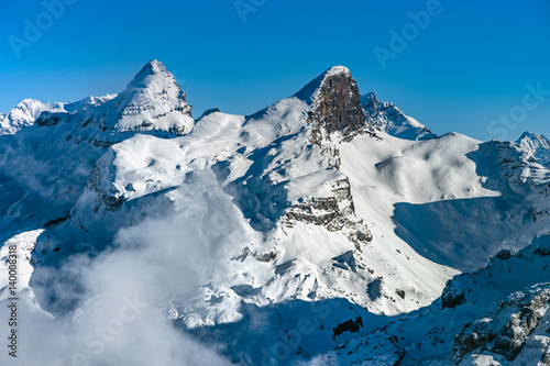 Beautiful mountains in snow. Evening aerial view with shadows.