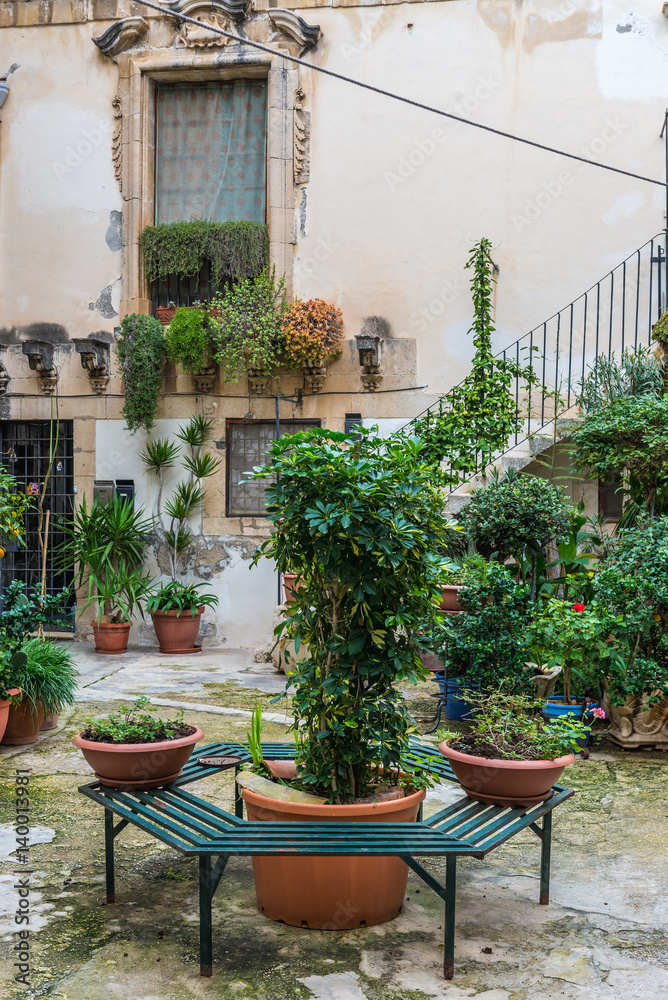 House courtyard on the Ortygia isle - old town of Syracuse on Sicily island, Italy