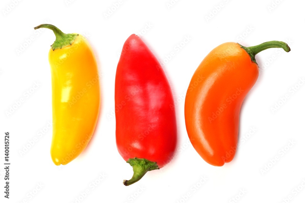 Fotografie Three mini sweet peppers, yellow, red and orange isolated on a white background