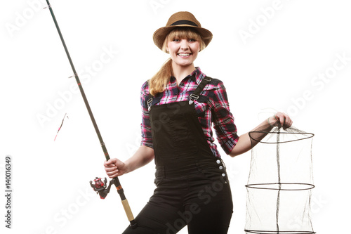 Happy woman holding fishing rod and keepnet photo