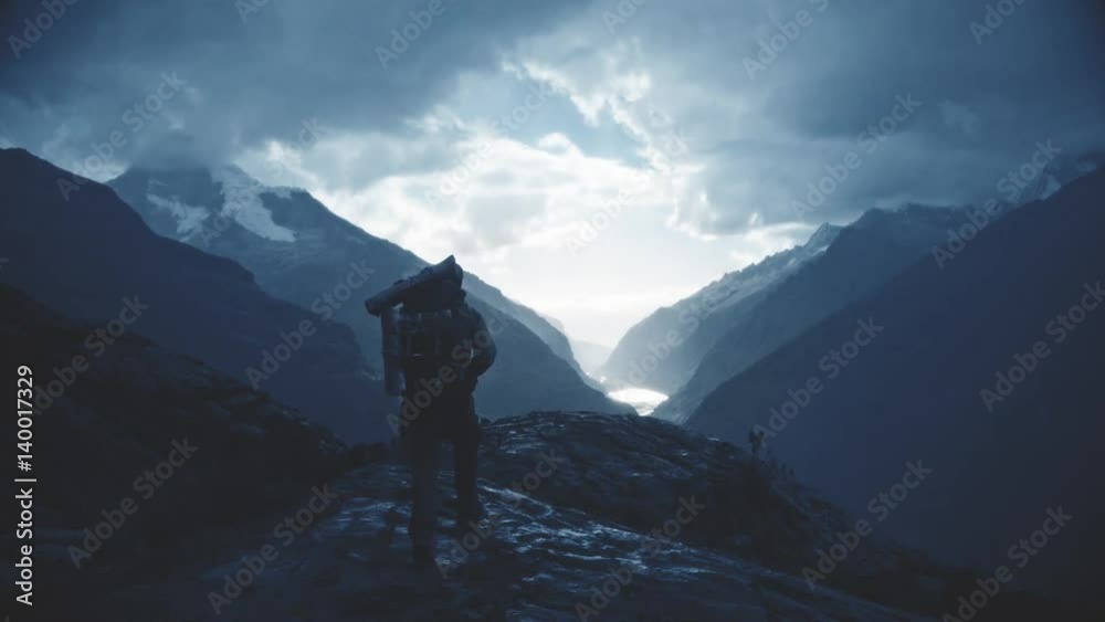 Silhouette of a backpacker walking on the peak of a mountain, Santa cruz Trek, Peru. Slow motion. Silhouette of a backpacker walking on the peak of a mountain, Santa cruz Trek, Peru. Slow motion.