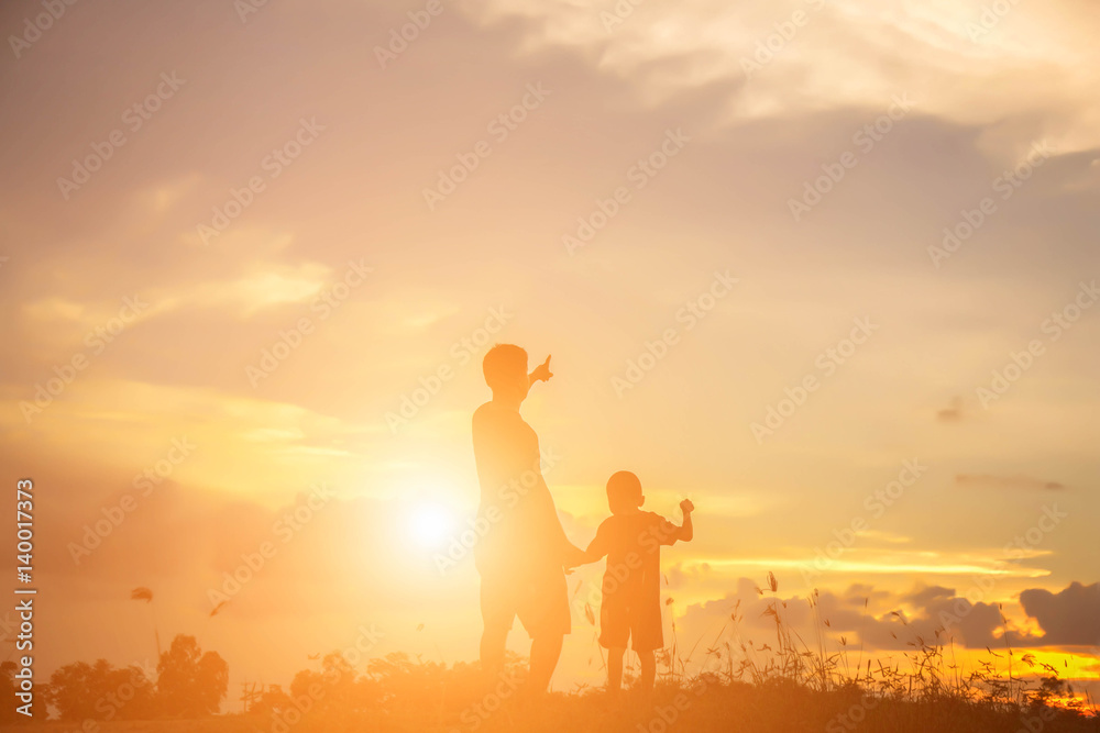 Fototapeta premium Father took the baby learn to walk at sunset.