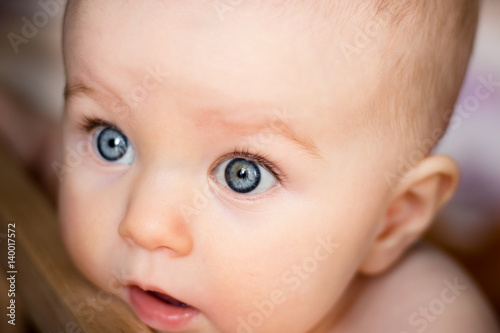 Baby surprised with big blue eyes