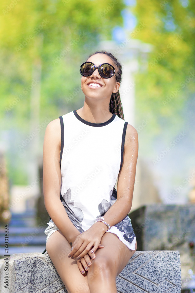Portrait of Smiling Young African American Teenager Girl With Plenty of Dreadlocks Posing in Park Outdoors. Portrait of Smiling Young African American Teenager Girl With Plenty of Dreadlocks Posing in Park Outdoors.