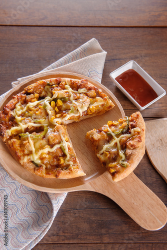 Delicious tasty pizza with on wooden table