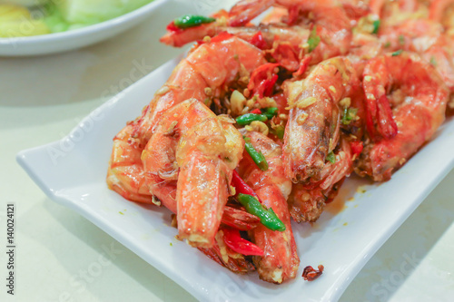 roasted prawns in white plate. © Phongsak