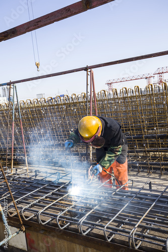 In the construction site, the welding workers at work