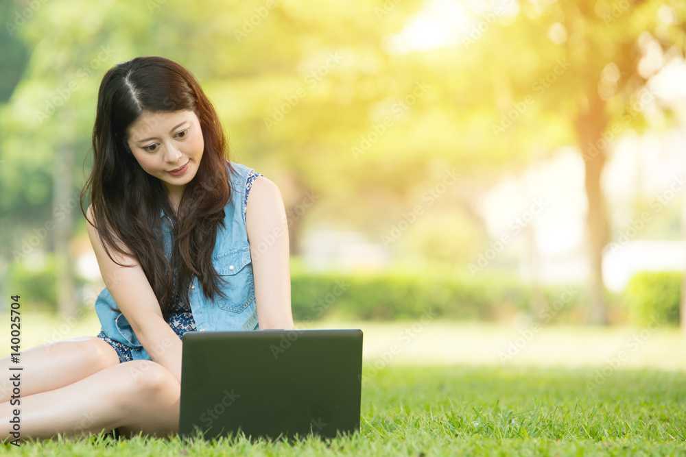 beautiful asian woman using computer in outdoor park beautiful asian woman using computer in outdoor park