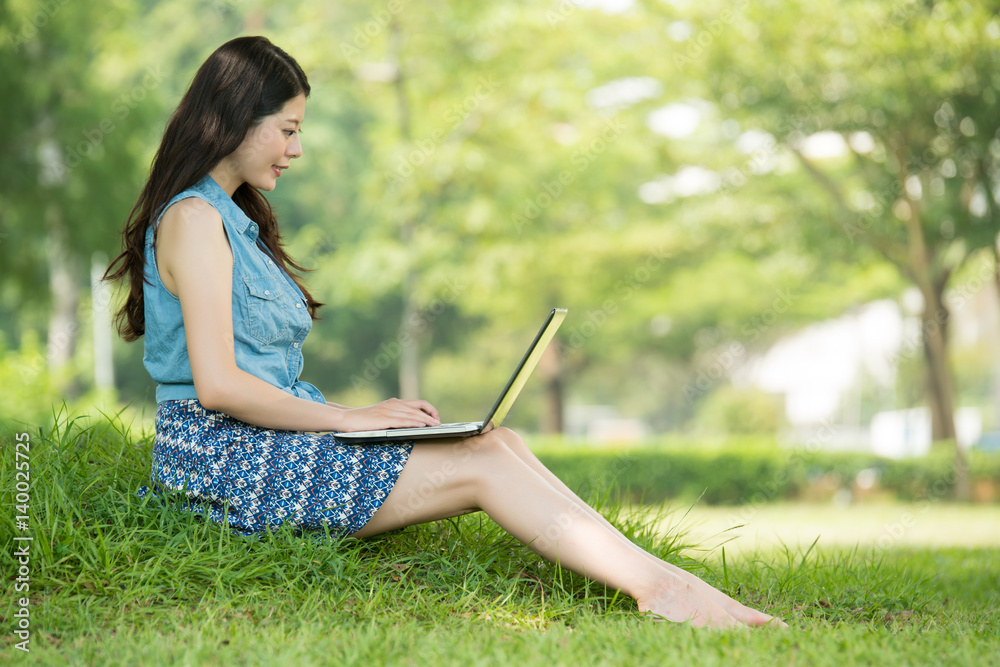 beautiful asian woman using computer in outdoor park beautiful asian woman using computer in outdoor park