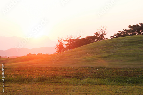 Sunset with grass garden on Mountain Background 
