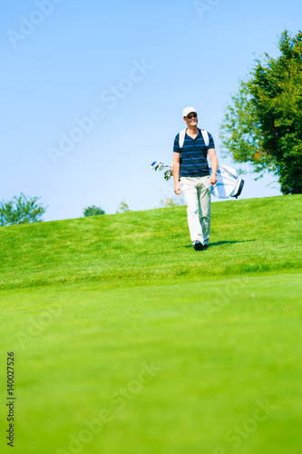 Man Walking To His Golf Ball