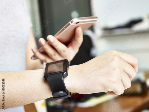 woman with smart phone and watch