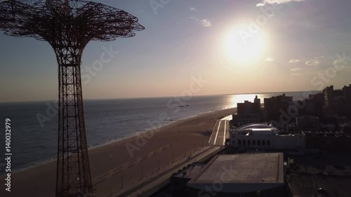 daytime flying past Parachute Jump Tower in Coney Island towards sun photo