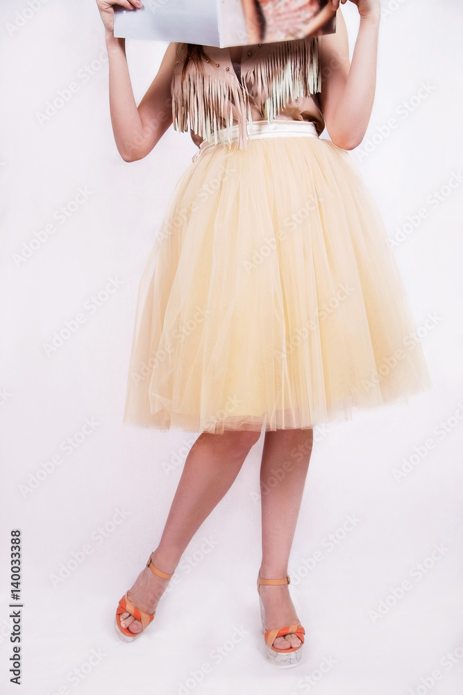 Naklejka premium Beautiful fashion girl holding in tulle skirt