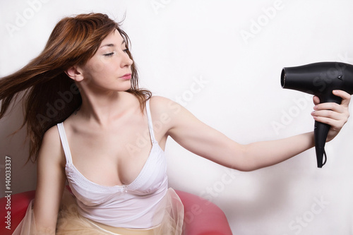 fashion girl with hair dryer on white background