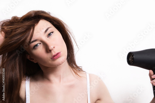 fashion girl with hair dryer on white background