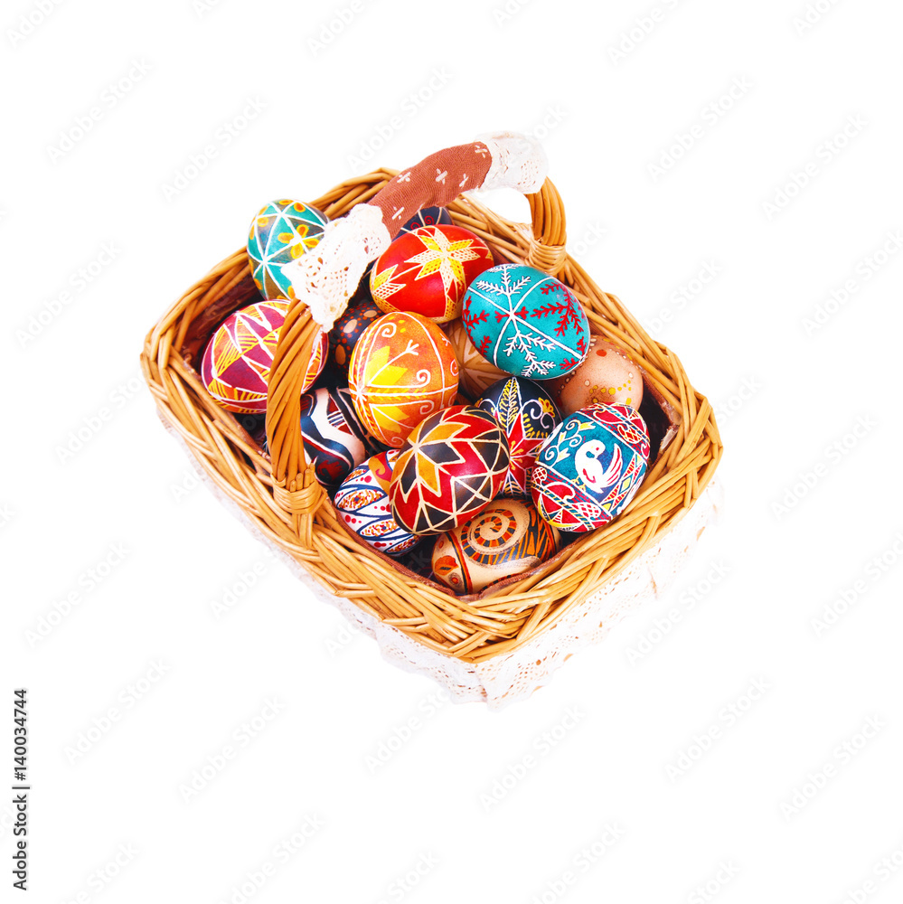Easter eggs in a basket, isolated on a white background.