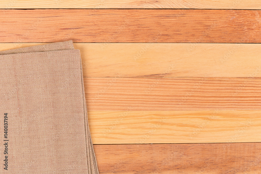 Fabric on wooden table. Soft brown woven linen fabric texture / white wood texture background
