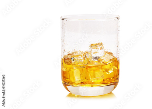 Glass of scotch whiskey and ice on a white background.