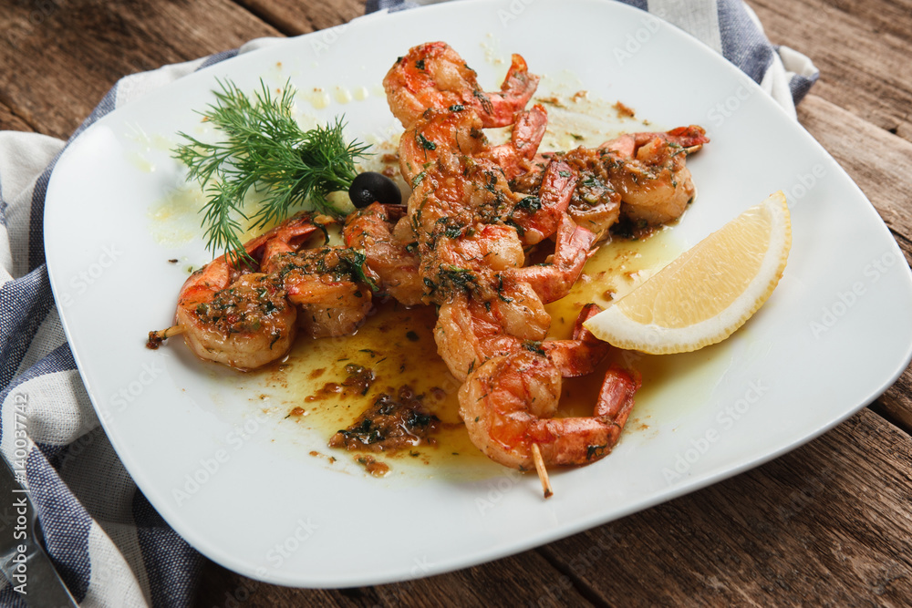 Served table with appetizing japanese food. Tasty fried shrimps with spices, herbs and lemon, top view. Appetizing meal. mediterranean food concept Served table with appetizing japanese food. Tasty fried shrimps with spices, herbs and lemon, top view. Appetizing meal. mediterranean food concept