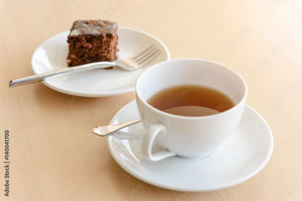 cup of hot tea with brownie on wooden table cup of hot tea with brownie on wooden table