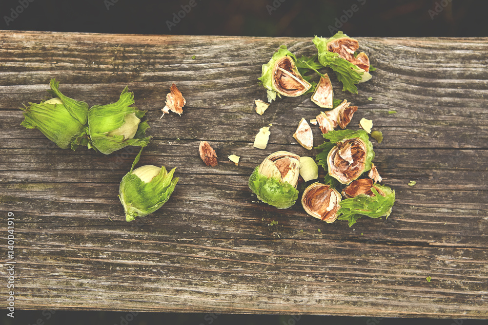 freshly cracked hazelnuts on wooden naturale background