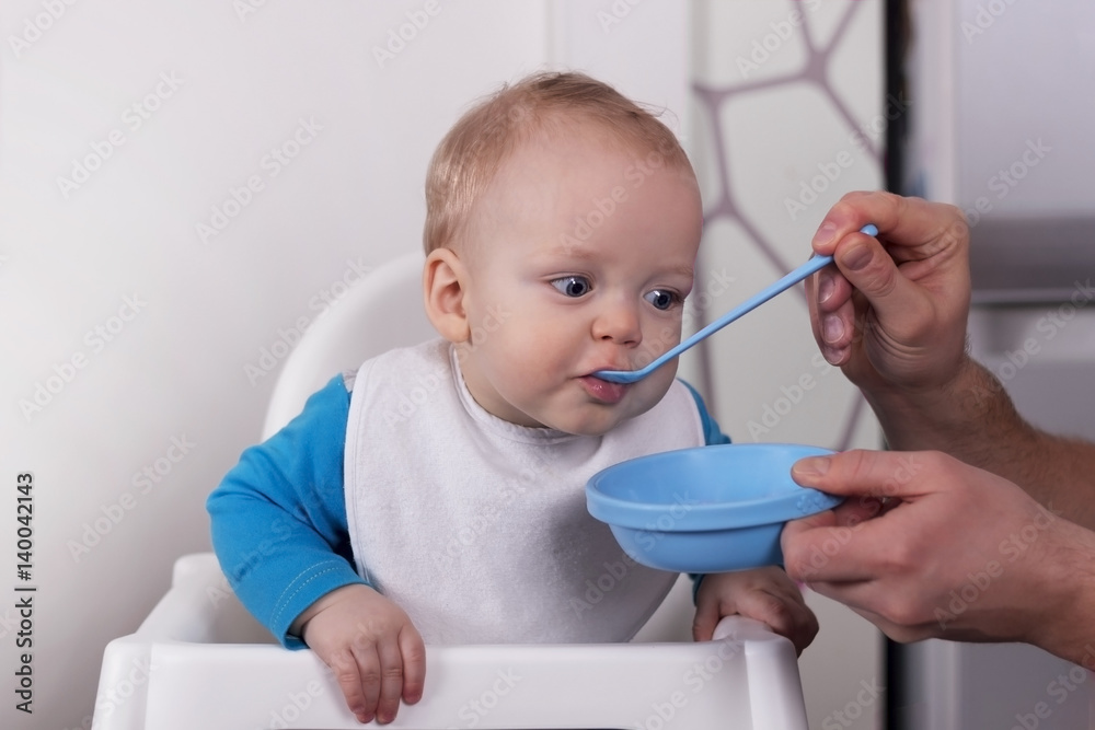 Father feeding his little cute son Father feeding his little cute son