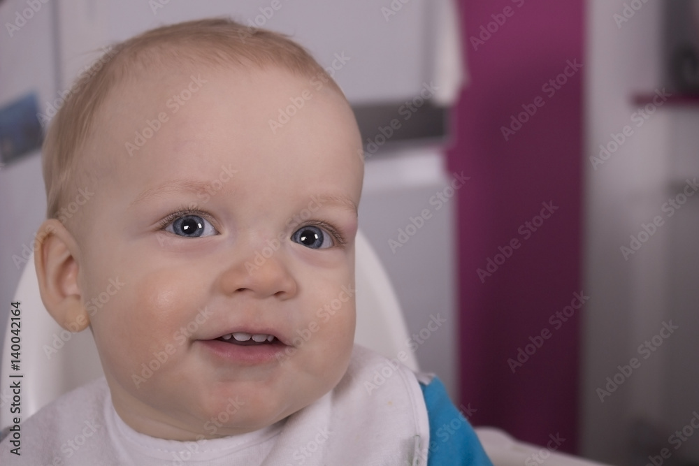 Attractive infant child with spoon in his mouth
