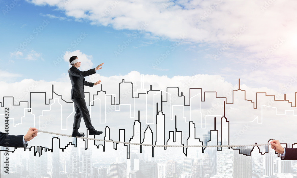 Business concept of risk support and assistance with man balancing on rope Business concept of risk support and assistance with man balancing on rope
