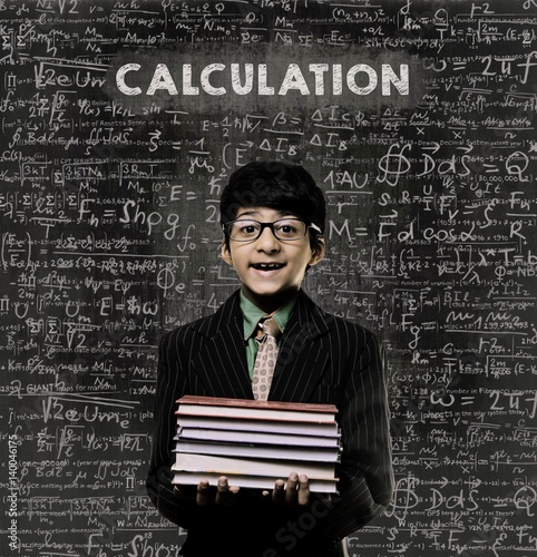 Calculation. Genius Little Boy Holding Book Wearing Glasses Chalkboard photo