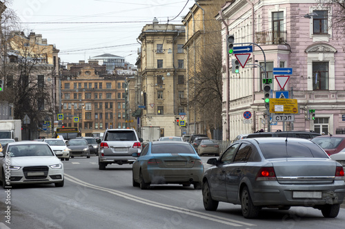 cars driving down city street, Saint Petersburg, buildings © Elena