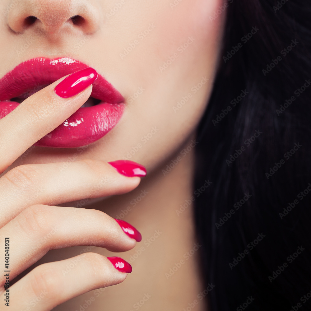 Naklejka premium Pink Female Lips and Manicure Hand Close up. Lip Gloss Makeup, Beauty Background